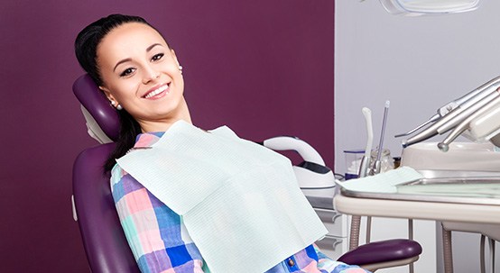 Woman smiling at  the dentist