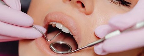 Close up of dentist examining woman’s mouth