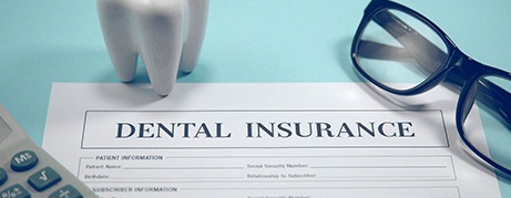 Dental insurance form on blue desk