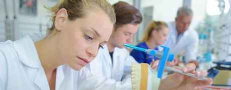 Female dental lab technician working on dentures