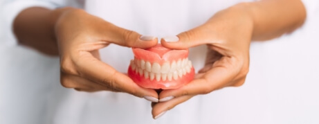 Dentist holding a set of full dentures