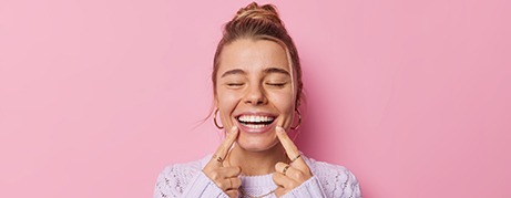 happy woman pointing to her smile